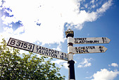 Road sign on the B3153 pointing to Langport, Taunton, Street, Glastonbury, Ilchester and Yeovil